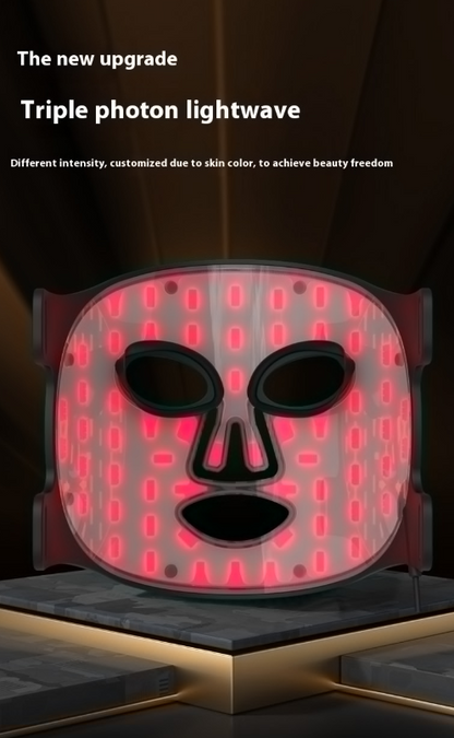 LED face mask lit up in warm red light
